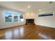 Spacious living room features wood flooring, a brick fireplace, recessed lighting, and large windows at 2317 Valrico Forest Dr, Valrico, FL 33594