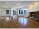 Spacious living room with hardwood floors, fireplace, and plenty of natural light from the many windows at 2317 Valrico Forest Dr, Valrico, FL 33594