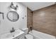 Modern bathroom featuring a vanity, toilet, and tiled shower-tub combo with wooden-look tiles at 2353 Shelley St # 8, Clearwater, FL 33765