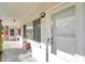 Exterior entrance of unit with white door and screen, showcasing building details and natural light at 2353 Shelley St # 8, Clearwater, FL 33765