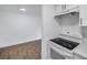 Updated kitchen featuring white cabinets, countertops, and modern appliances with open access to living area at 2353 Shelley St # 8, Clearwater, FL 33765