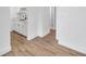 Open-concept kitchen with modern white cabinetry and wood-style floors, seamlessly connecting spaces at 2353 Shelley St # 8, Clearwater, FL 33765