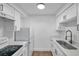 Modern kitchen with white cabinets, sleek countertops, and stainless steel appliances, including stove and refrigerator at 2353 Shelley St # 8, Clearwater, FL 33765