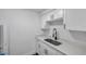 Bright kitchen features white cabinets, speckled countertops, stainless steel sink, and modern black faucet at 2353 Shelley St # 8, Clearwater, FL 33765