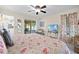 Comfortable bedroom with ceiling fan and sliding door access to the patio area at 3699 N Chamberlain Blvd, North Port, FL 34286