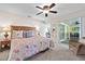 Charming bedroom with ceiling fan, sliding door to the patio, and bedside tables for convenience at 3699 N Chamberlain Blvd, North Port, FL 34286