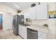 Well-maintained kitchen with stainless steel appliances and white cabinets at 3699 N Chamberlain Blvd, North Port, FL 34286