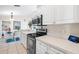 Clean kitchen with stainless steel appliances, white cabinetry, and modern countertops at 3699 N Chamberlain Blvd, North Port, FL 34286