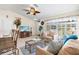 Comfortable living room filled with natural light, a ceiling fan, tile floors, and relaxing decor at 3699 N Chamberlain Blvd, North Port, FL 34286