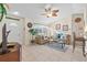 Cozy living room featuring neutral paint, tile floors, ceiling fan, and plenty of natural light at 3699 N Chamberlain Blvd, North Port, FL 34286