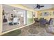Covered patio featuring outdoor furniture, ceiling fan, and seamless transition to the interior living space at 3699 N Chamberlain Blvd, North Port, FL 34286