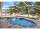 Backyard screened-in pool with lounge area and patio at 3699 N Chamberlain Blvd, North Port, FL 34286