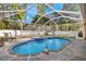 Screened-in pool featuring a built-in spa and attractive patio at 3699 N Chamberlain Blvd, North Port, FL 34286
