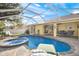 Backyard pool and patio area featuring an in-ground spa and ample seating at 3699 N Chamberlain Blvd, North Port, FL 34286