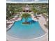 Aerial view of a community pool with palm trees at 11826 Sky Acres Ter, Bradenton, FL 34211