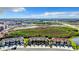 Aerial view showcases townhomes, the community pond, landscaping, and surrounding area at 11826 Sky Acres Ter, Bradenton, FL 34211