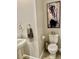 Modern half-bath with wood-look tile floor, artwork, and fixtures at 11826 Sky Acres Ter, Bradenton, FL 34211