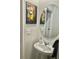 Stylish half-bath features a modern pedestal sink and unique Buddha painting at 11826 Sky Acres Ter, Bradenton, FL 34211