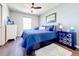 Comfortable bedroom with wood-look floor, ceiling fan, and coastal decor at 11826 Sky Acres Ter, Bradenton, FL 34211