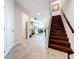 Inviting entryway with wood-look tile, wood stairs, and views to the kitchen and living spaces at 11826 Sky Acres Ter, Bradenton, FL 34211