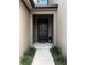 Welcoming front entryway with a black door, neutral tones, and decorative plants for inviting curb appeal at 11826 Sky Acres Ter, Bradenton, FL 34211
