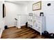 Upstairs landing with wood-look flooring and decorative chest of drawers at 11826 Sky Acres Ter, Bradenton, FL 34211