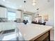 Bright kitchen featuring a quartz countertop island, modern appliances and fixtures, and pendant lighting at 11826 Sky Acres Ter, Bradenton, FL 34211
