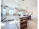 A bright, modern kitchen with a central island featuring a quartz countertop and wood accents at 11826 Sky Acres Ter, Bradenton, FL 34211