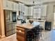 Bright kitchen boasts white cabinetry, stainless steel appliances, and a large island with barstool seating at 11826 Sky Acres Ter, Bradenton, FL 34211