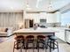 Modern kitchen featuring a center island with seating, open to the living area with stylish decorative wall at 11826 Sky Acres Ter, Bradenton, FL 34211