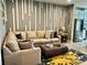 Inviting living area with a spacious sectional, trendy decor, and seamless connection to the modern kitchen at 11826 Sky Acres Ter, Bradenton, FL 34211