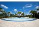 Expansive pool with blue tiled border and sunny skies at 11826 Sky Acres Ter, Bradenton, FL 34211