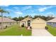 Charming single-story home with a well-manicured lawn and attached two-car garage at 13202 Golf Ridge Pl, Hudson, FL 34669