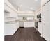 Modern kitchen with white cabinets, granite countertops, and stainless steel appliances at 13202 Golf Ridge Pl, Hudson, FL 34669
