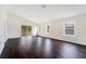 Bright living room featuring a vaulted ceiling, sleek flooring, and a seamless transition to outdoor spaces at 13202 Golf Ridge Pl, Hudson, FL 34669