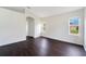 This spacious room features an archway, two windows for ample natural light, and dark wood-look flooring at 13202 Golf Ridge Pl, Hudson, FL 34669