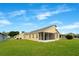Well-maintained single-story home featuring a screened lanai and lush green lawn at 13202 Golf Ridge Pl, Hudson, FL 34669