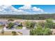 Neighborhood aerial view showing houses and wooded backdrops, highlighting the serene suburban setting with easy access to nature at 19648 Timberbluff Dr, Land O Lakes, FL 34638