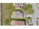 An aerial view showing a home's roof, lawn, patio, cars in driveway, nearby street, and neighborhood properties at 19648 Timberbluff Dr, Land O Lakes, FL 34638