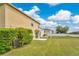 Expansive backyard with well-maintained lawn and view of neighboring houses under a clear sky at 19648 Timberbluff Dr, Land O Lakes, FL 34638