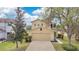 Charming two-story house showcasing its inviting curb appeal with a well-manicured lawn and attached two car garage at 19648 Timberbluff Dr, Land O Lakes, FL 34638