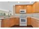 Bright kitchen features wooden cabinets, sleek appliances, and dark floors at 19648 Timberbluff Dr, Land O Lakes, FL 34638