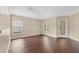 Bright living room with dark wood floors and large windows providing natural light at 19648 Timberbluff Dr, Land O Lakes, FL 34638