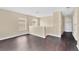 Open loft area featuring wood floors, staircase, and a view of the hallway with a white door at 19648 Timberbluff Dr, Land O Lakes, FL 34638