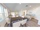 Bright and airy living area featuring an open floor plan, kitchen island with seating, and ample natural light from large windows at 14699 Italy Ave, Dade City, FL 33523