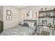 Cozy bedroom with unique artwork, comfortable bed, industrial-style shelving, and decorative accents at 1785 Trailhead Ln, Zephyrhills, FL 33541