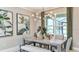 Elegant dining room featuring a modern chandelier, large windows, and stylish decor at 1785 Trailhead Ln, Zephyrhills, FL 33541