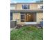 Rear exterior of property with screened in back porch and green grass at 1238 Standridge Dr, Wesley Chapel, FL 33543