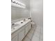 Well-lit bathroom featuring a double sink vanity, tiled floor, and a large mirror at 1238 Standridge Dr, Wesley Chapel, FL 33543