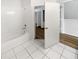 Bathroom featuring tiled floors, a shower-tub combination, and access to other rooms at 1238 Standridge Dr, Wesley Chapel, FL 33543